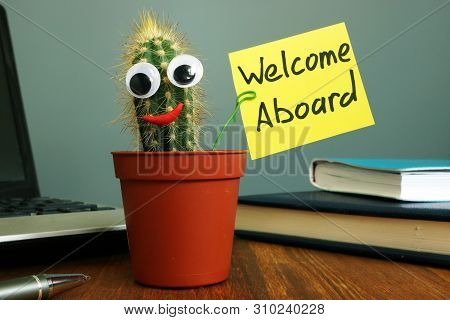 Welcome Aboard Concept. Funny Cactus On Workplace In The Office.