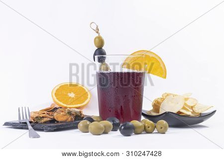 Vermouth, Traditional Spanish Appetizer With Olives, Black Olives, Potato Chips Ans Mussels. Oranges