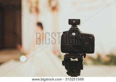 Close-up Of Professional Dslr Digitak Camera Attached With Tripod In Wedding Ceremony And With Bride