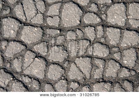 Sprickor på grå trottoaren