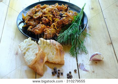 Traditional Polish bigos on the wooden table 
