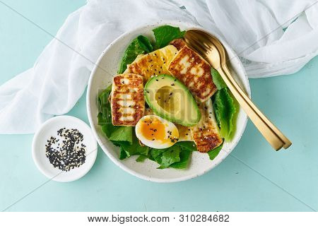 Keto Ketogenic Diet Soft Boiled Eggs With Grilled Haloumi, Avocado And Lettuce, Mediterranean Cuisin