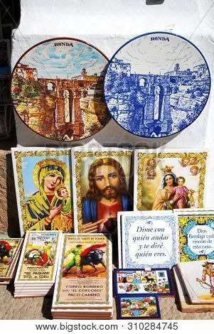 Ronda, Spain - May 5, 2008 - Colourful Ceramic Plates And Religious Plaques Outside A Shop In The Ol