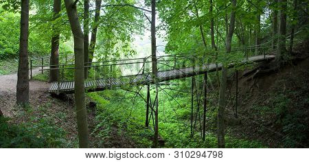 The Panoramic View Of A Footpath Bridge In Birstonas Resort Town Hill Park (lithuania)
