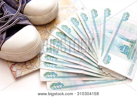 Russian Money On A White Background, Money Fan In Hand. Travel Agency. Buying Tickets.