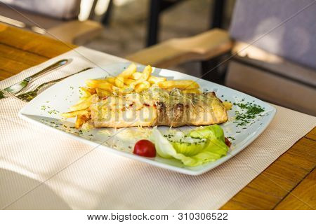 Traditional Montenegrin Meat Negush Steak On A White Plate In A Restaurant.