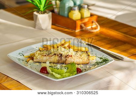 Traditional Montenegrin Meat Negush Steak On A White Plate In A Restaurant.
