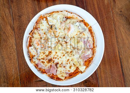 Simple And Basic Normali Solated Full Circle Pizza In White Dish On Wood Table With Clipping Paths