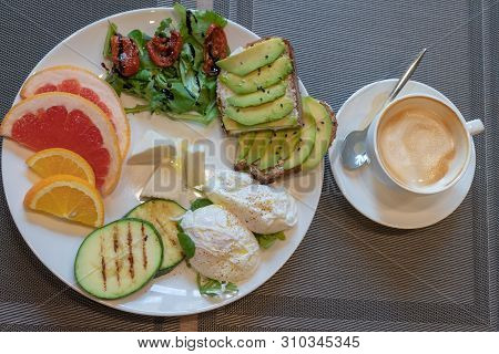Delicious Healthy Breakfast. Toasts With Avacado, Dried Tomatoes, Cheese, Apelsin, Grapefruit, Poach