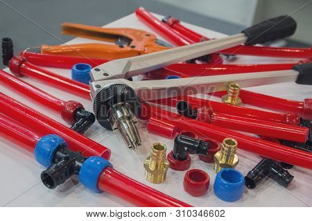 Water Pipes Pex And Mounting Tools On The Table. Plumbing