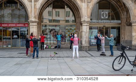 Munich, Bavaria, Germany - May 28, 2019. Group Of Unidentified People Practicing Tai Chi In Front Of
