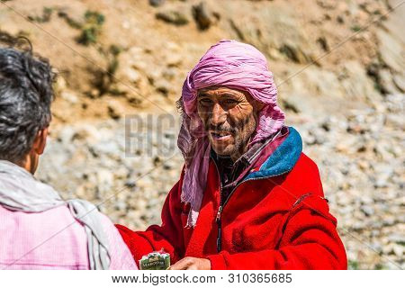 Midelt, Morocco - October 05, 2013. Berber Shepherd Offering Cigarette