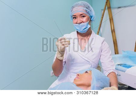 Aged Woman Doing Mesothreads And Thread Lifting, Cosmetology. Cosmetic Procedure To Eliminate Signs 