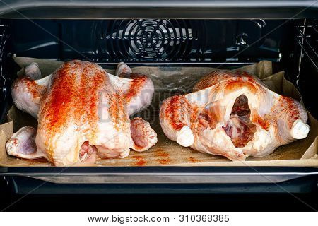 Two Whole Chickens In Paprika On Baking Tray Ready To Cook In Oven.