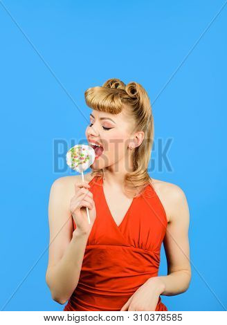 Satisfed Woman Eating Piece Of Candy. Sexy Blonde Girl Licking Lollipop. Beautiful Woman With Fashio