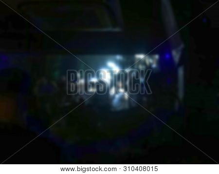 Blurred Crowd Of Enjoyment Peolple In Night Disco Club Background.