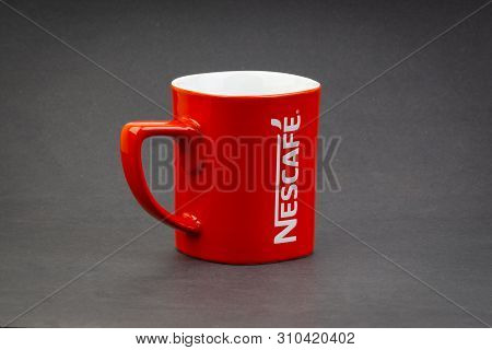 Kuala Lumpur, Malaysia - July 03, 2019; Promotional Red Nescafe Mug On Dark Background. Selective Fo