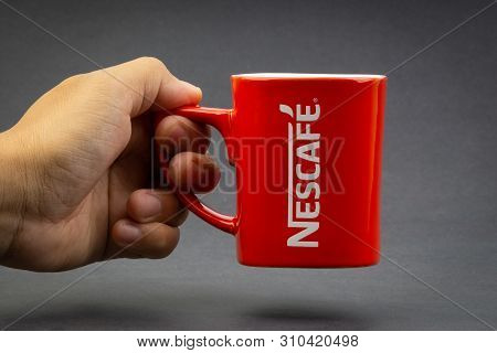 Kuala Lumpur, Malaysia - July 03, 2019; Promotional Red Nescafe Mug On Dark Background. Selective Fo