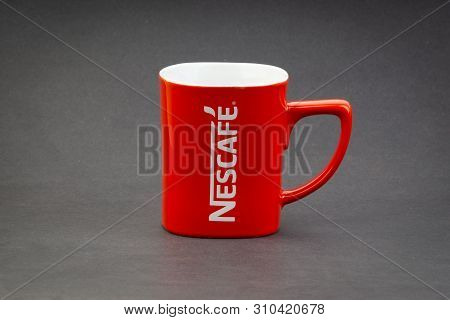Kuala Lumpur, Malaysia - July 03, 2019; Promotional Red Nescafe Mug On Dark Background. Selective Fo