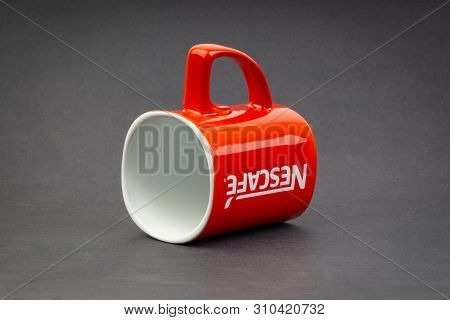 Kuala Lumpur, Malaysia - July 03, 2019; Promotional Red Nescafe Mug On Dark Background. Selective Fo
