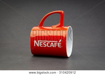 Kuala Lumpur, Malaysia - July 03, 2019; Promotional Red Nescafe Mug On Dark Background. Selective Fo
