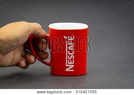 Kuala Lumpur, Malaysia - July 03, 2019; Promotional Red Nescafe Mug On Dark Background. Selective Fo