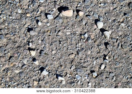 Stone Asphalt Texture Of Road And Pebbles Circle. Grey Asphalt Road And And A Hand-made Circle Of Gr