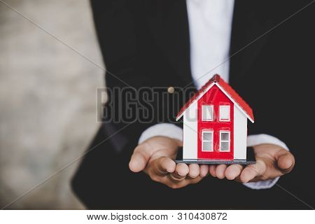 Real Estate Agent Holding House Model, Real Estate Concept