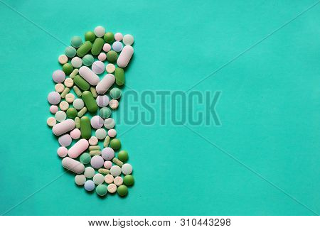 Medicine Pills Tablets Capsules In Shape Of Human Kidney In Blue Background With Space For Text