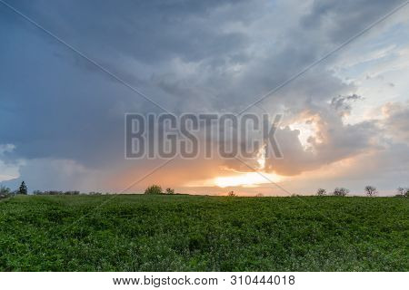 Fragment Of The Sky With Cumulus Clouds And Sun Over The Fild At Sunset