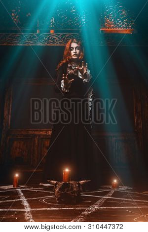 A portrait of a scary witch in the wooden house. Magic, dark force, spell. 