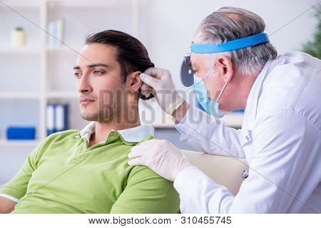 Male patient visiting doctor otolaryngologist