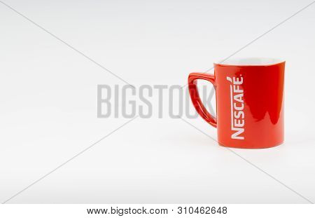 Kuala Lumpur, Malaysia - July 03, 2019:  Promotional Red Nescafe Mug On White Background. Selective 