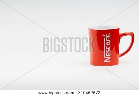 Kuala Lumpur, Malaysia - July 03, 2019:  Promotional Red Nescafe Mug On White Background. Selective 