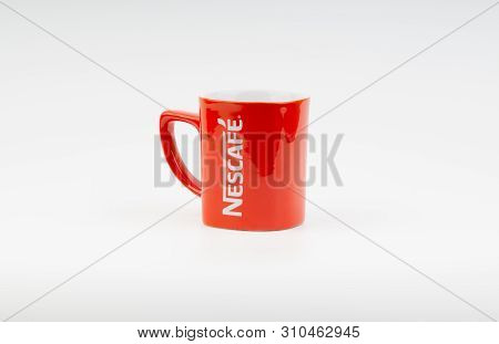 Kuala Lumpur, Malaysia - July 03, 2019:  Promotional Red Nescafe Mug On White Background. Selective 