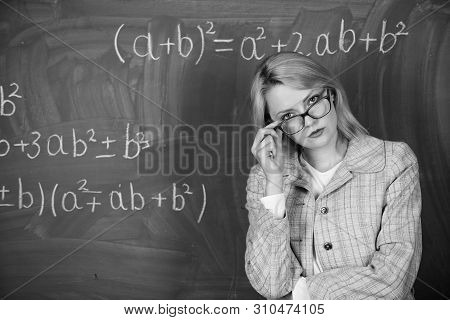 Teacher On School Lesson At Blackboard. Woman In Classroom. School. Home Schooling. Serious Woman. B