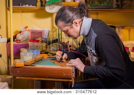 Professional Male Skinner, Tanner Making Decorative Details On Leather Playing Field For Strategy Bo