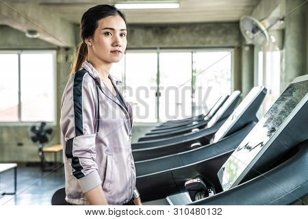 Sport Women Running On Threadmill In Fitness Gym