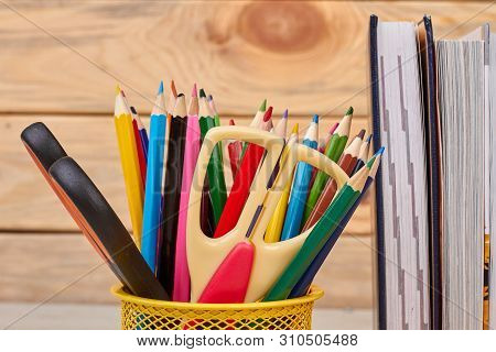 Close Up Colorful School Supplies Background. Books And Metal Holder With Stationery Items. Back To 