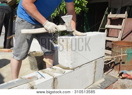 Bricklayer Builder Laying Autoclaved Aerated Concrete Blocks, Aac For New House Wall.