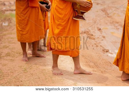 There Was A Merit Making In The Morning. People Would Scoop Food Into The Alms Of Many Monks.