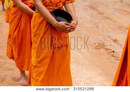 There Was A Merit Making In The Morning. People Would Scoop Food Into The Alms Of Many Monks.