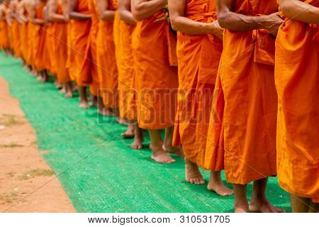 There Was A Merit Making In The Morning. People Would Scoop Food Into The Alms Of Many Monks.