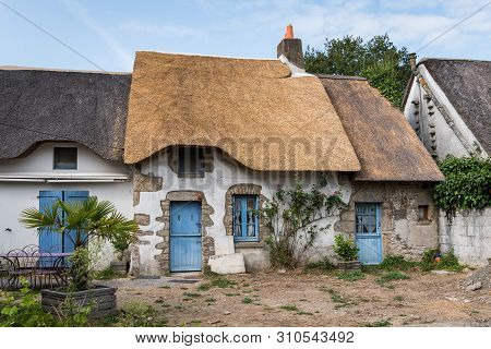 Old Houses In Saint Lyphard (france) With Thatched Roofs