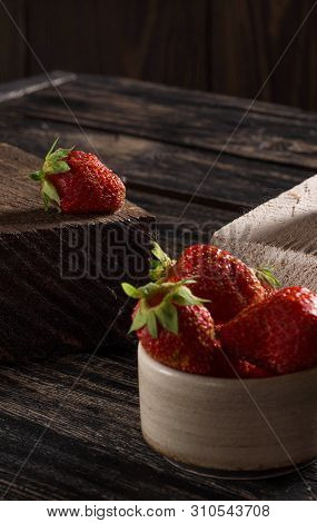 Composition On A Wooden, Dark Background, Consisting Of Fresh Strawberries, Which Lies On The Wooden