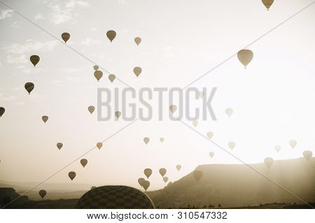 Hot Air Balloons Landing In A Mountain Cappadocia Goreme National Park Turkey.