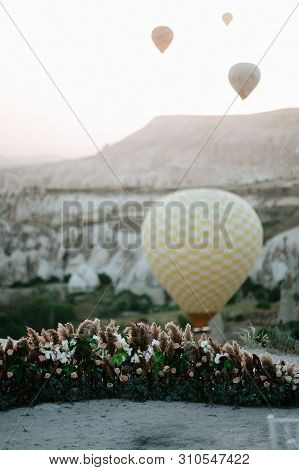 Hot Air Balloons Landing In A Mountain Cappadocia Goreme National Park Turkey.
