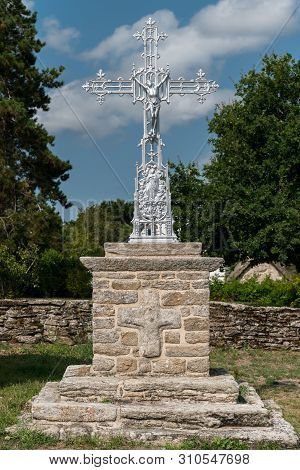 Modern Metal Cross Standing On A Stone Wall In France