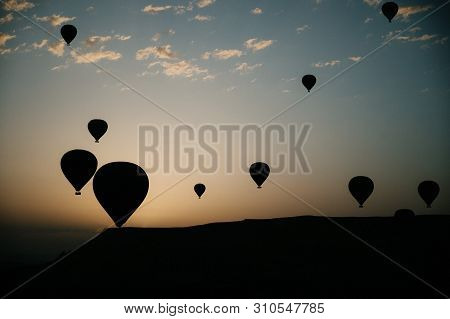 Hot Air Balloons Landing In A Mountain Cappadocia Goreme National Park Turkey.