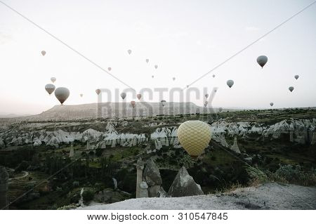 Hot Air Balloons Landing In A Mountain Cappadocia Goreme National Park Turkey.